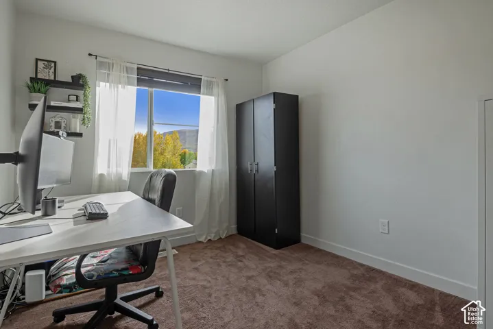 Interior room featuring wall-to-wall carpeting and a window providing natural light and mountainous scenery