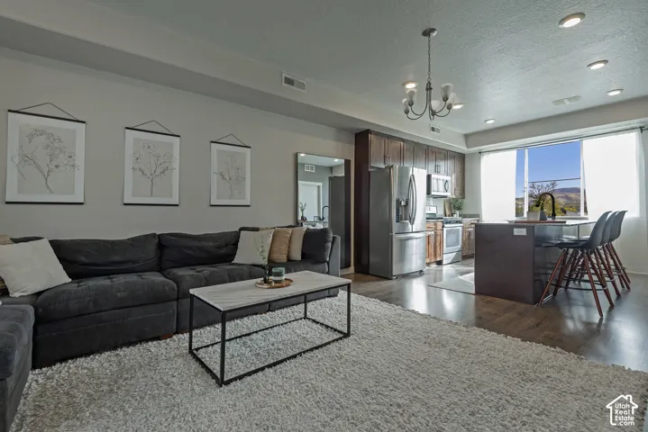 Kitchen featuring dark-finish cabinetry, stainless steel appliances, and a central island with integrated seating