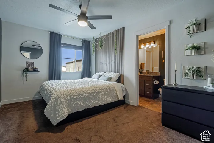 Bedroom featuring a vertical wood-slat accent wall, ceiling fan with integrated light, single-pane window, and wall-to-wall carpeting