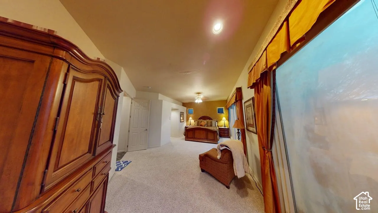 Vaulted ceiling, wall-to-wall carpeting, and recessed lighting