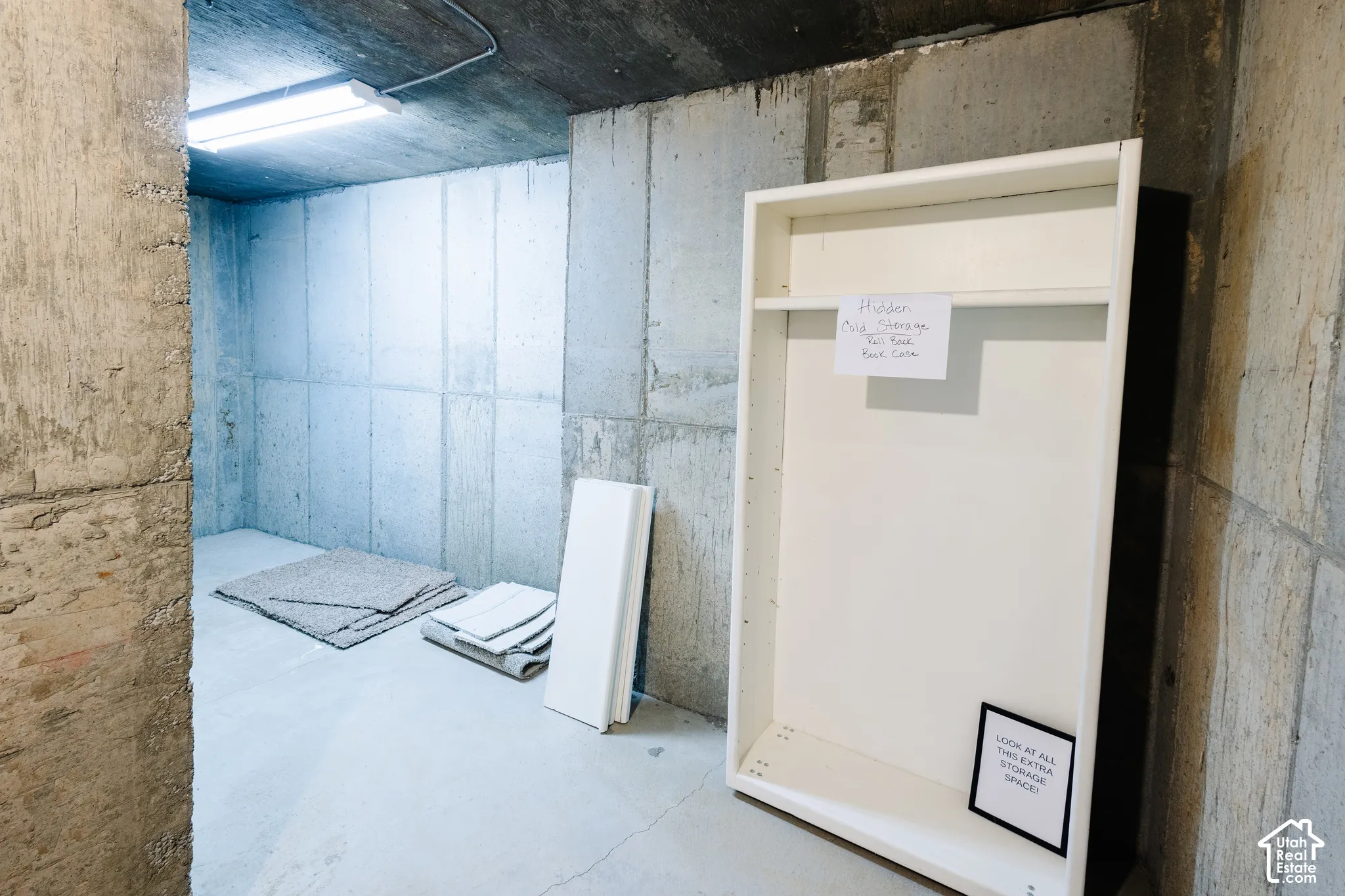 Concrete foundation walls, concrete floor, and linear overhead lighting