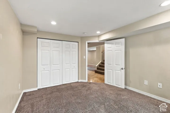 Neutral-toned walls, recessed lighting, multi-panel doors, and wall-to-wall carpeting
