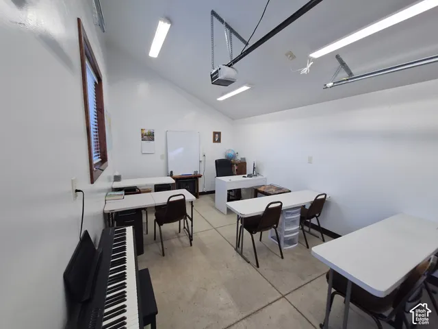 Detached garage with finished interior and lighting.