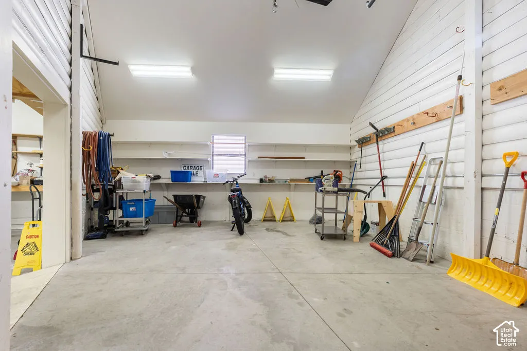 Spacious garage featuring concrete flooring and overhead fluorescent lighting
