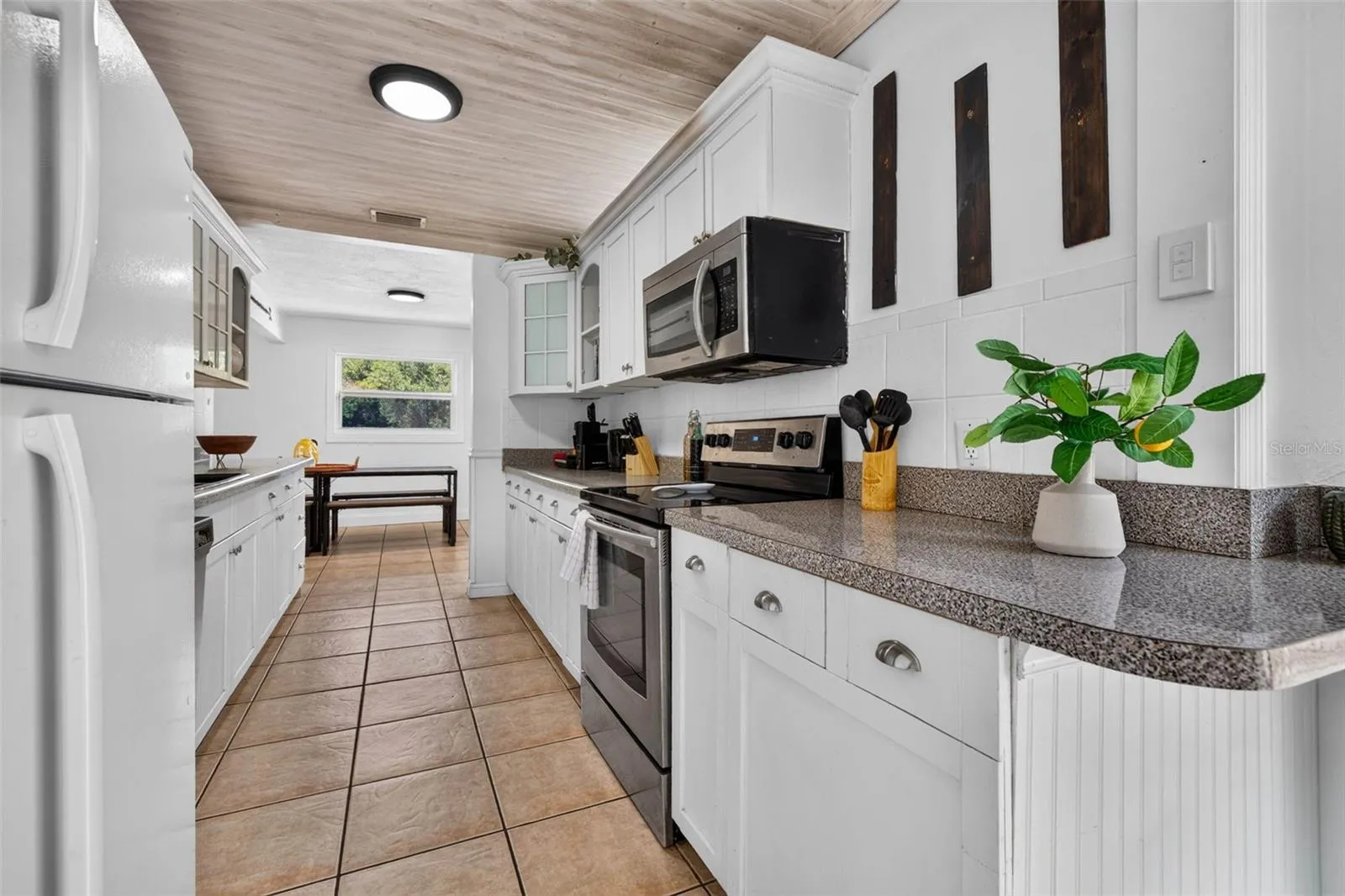 All white cabinets and decorative ceiling.