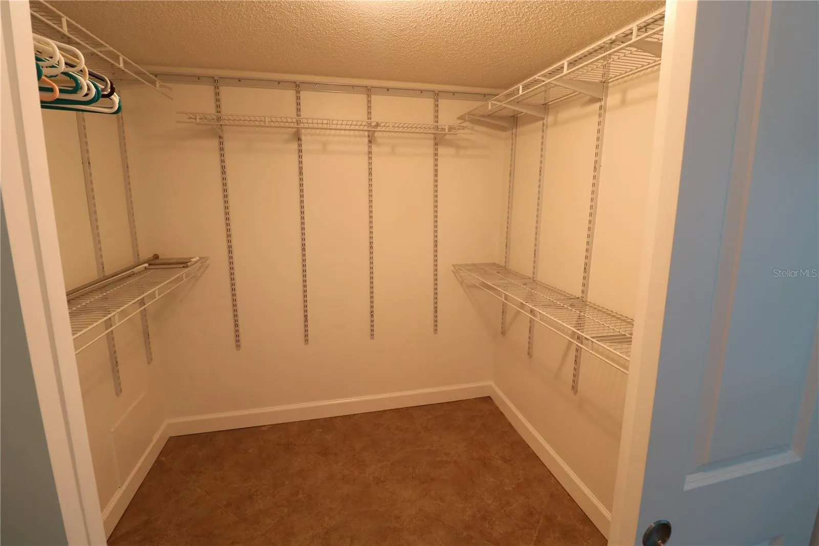 Primary bedroom walk in closet