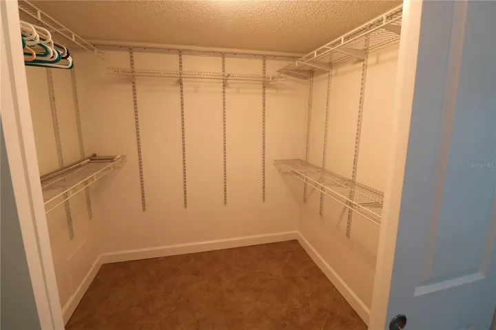 Primary bedroom walk in closet