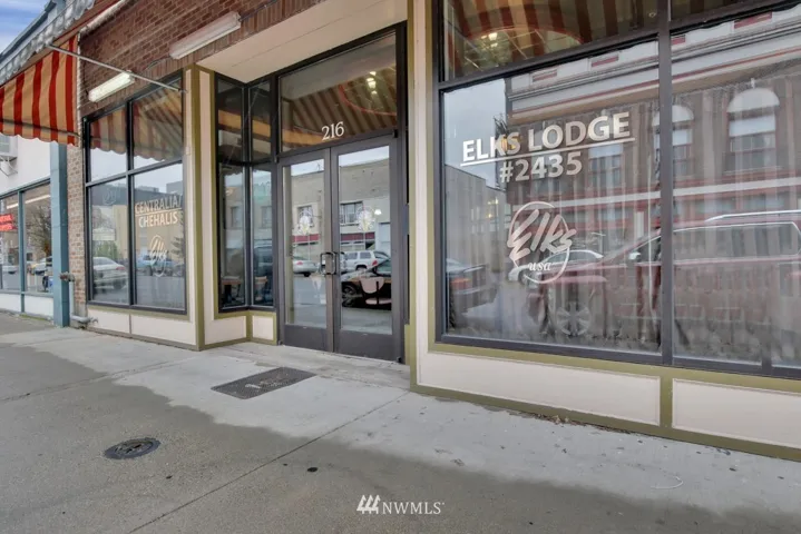 Smart looking main entrance on Tower Ave with a lighted awning and recessed front door.