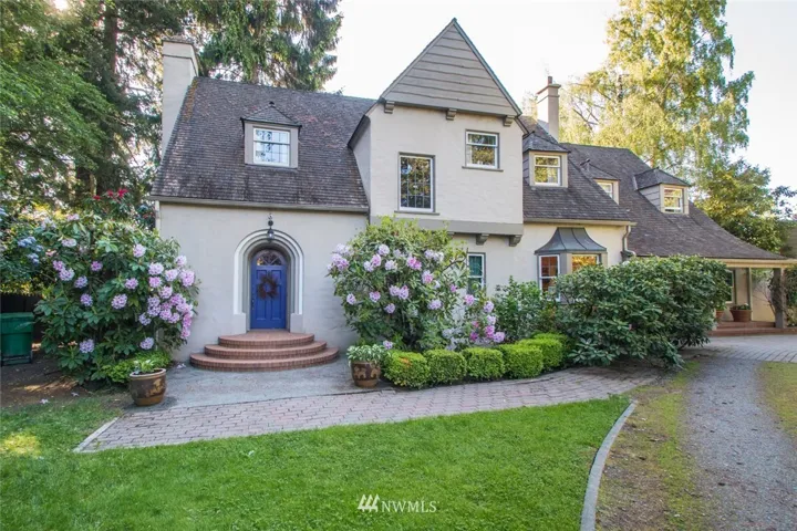 Storybook French country inspired home situated on a private .62 acre in-town lot with circular driveway.