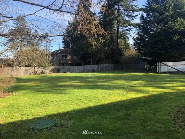 Fenced on north and east side. Northbeach Road is on the west side. A frame home is on the south side.