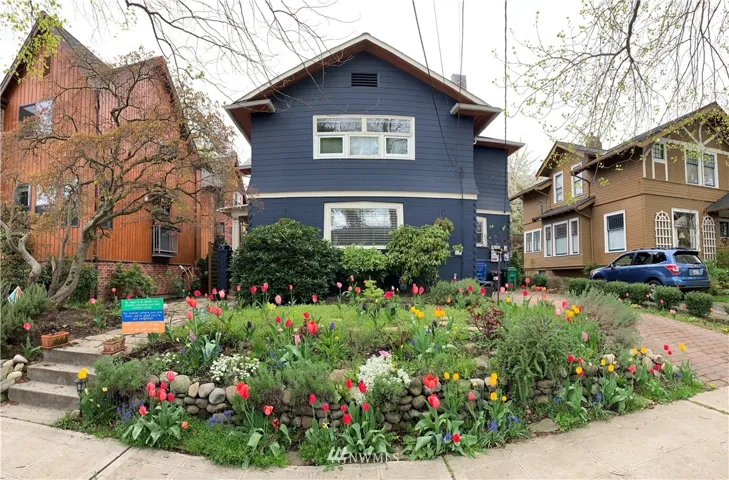 This home has been well loved from the front yard to the back fence. Front door is up the stairs with lovely plantings in front yard and an off-street parking space (fits two cars) on the right. Front living room and master bedroom upstairs enjoy the view of the front yard.