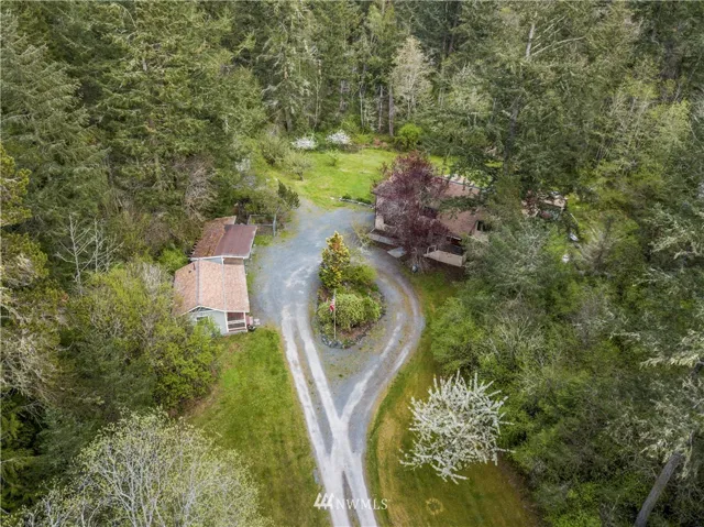 Five acres of pretty pristine beauty -- a birdwatcher's paradise!  Nearly 2,300 sq.ft. of home, with decks, fruit trees, nature trails, and more.