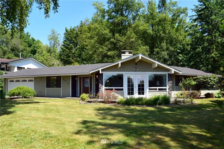 This gorgeous custom home has French doors to the front patio and the rear. Beautifully designed and placed on the lot.