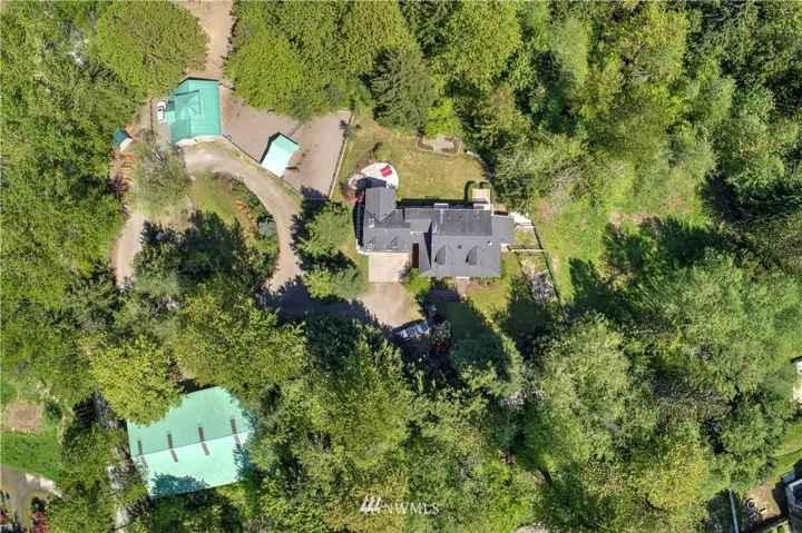 Arial view of house, 60 X 90 covered riding arena and barn.