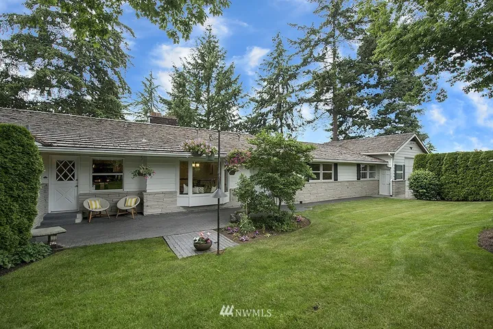 Hidden behind a privacy hedge is this sun drenched front courtyard