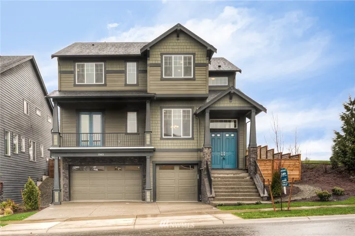 Beautiful curb appeal with a large 3-car wide driveway and garage. Don't miss the front balcony! This photo is of actual house.