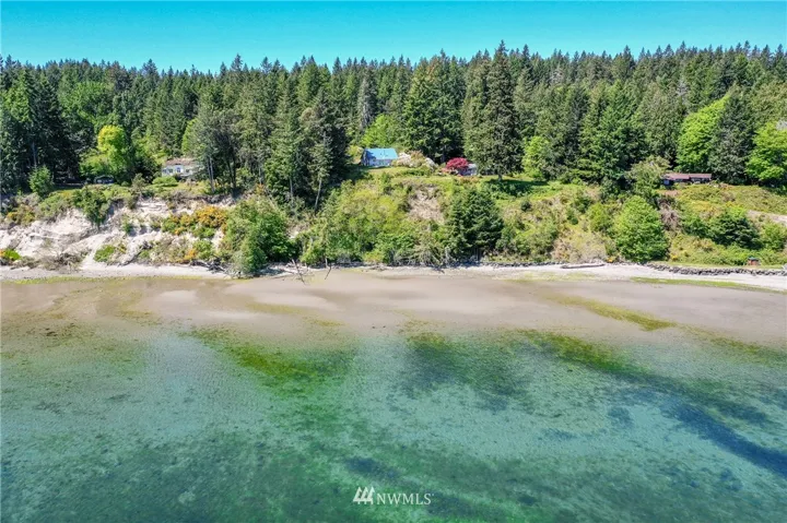 This Beach House with a blue metal roofed perched high on the bluff awaits you!