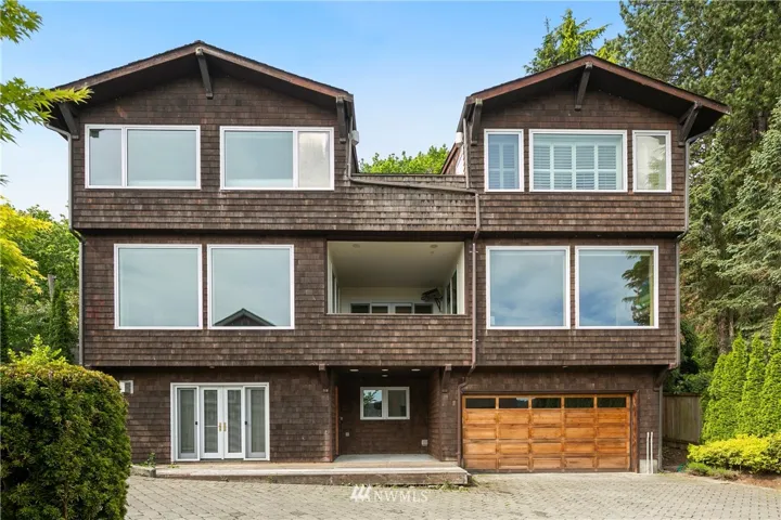 Large windows showcase the expansive views of Lake Washington and the Cascade Mountains. Two car garage and entrance into lower level suite.