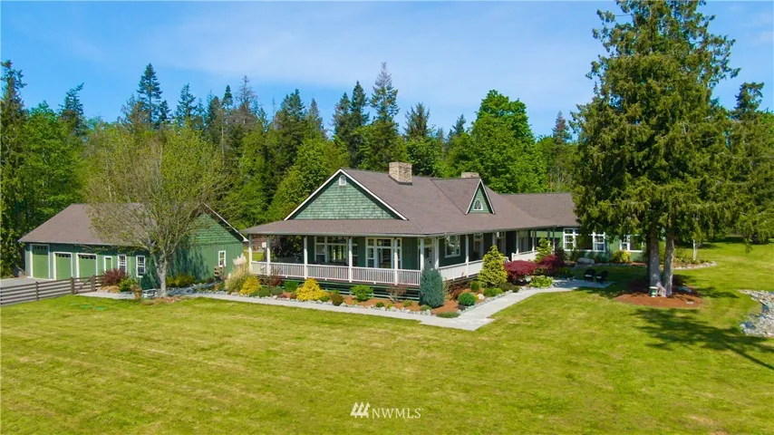 5 acre rambler with beautiful mature landscaping surrounding the 2,200 sf wrap around deck