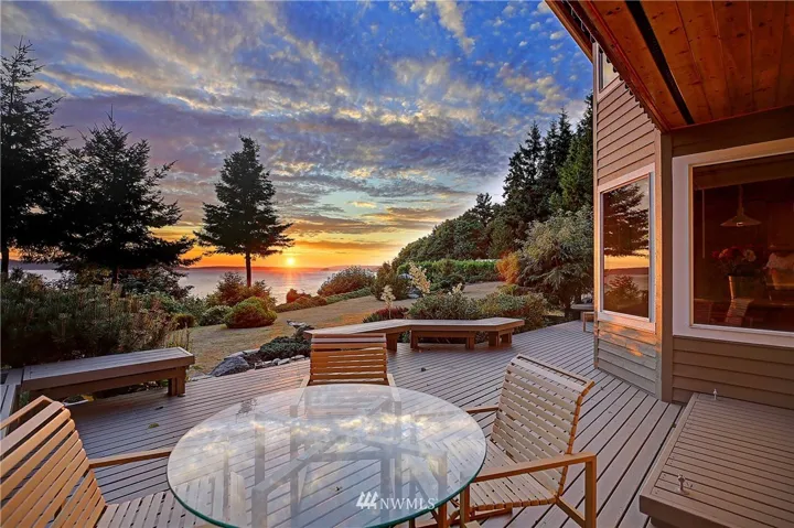 Imagine enjoying magical sunsets from your deck on this spectacular 2-acre high bluff property with stairs to a pristine beach!