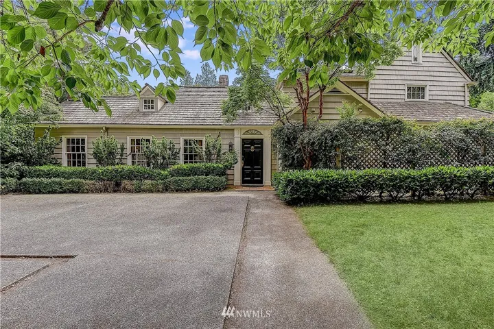 The home is situated on a near double lot that is fully fenced for privacy. The entry to the home is framed by Greek-style columns and symmetrical lines.