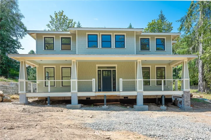 Huge front porch with rock pillars and gorgeous stairs. Yard will be full landscaped.