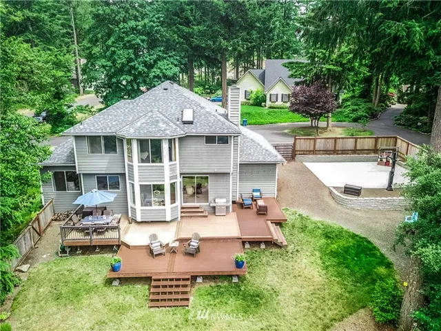 Total oasis out back with party deck, sport court, fire pit area, and room to play.