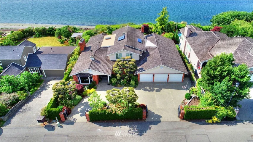 Living at the waters edge, watch the ferries crisscross the Sound, the cruise ships pass by on their way to Alaska, and dogs running up and down the beach at low tide.