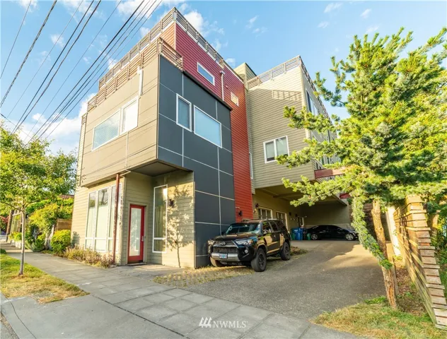 Exterior of home. Shows access to the ground floor unit and designated off street parking.