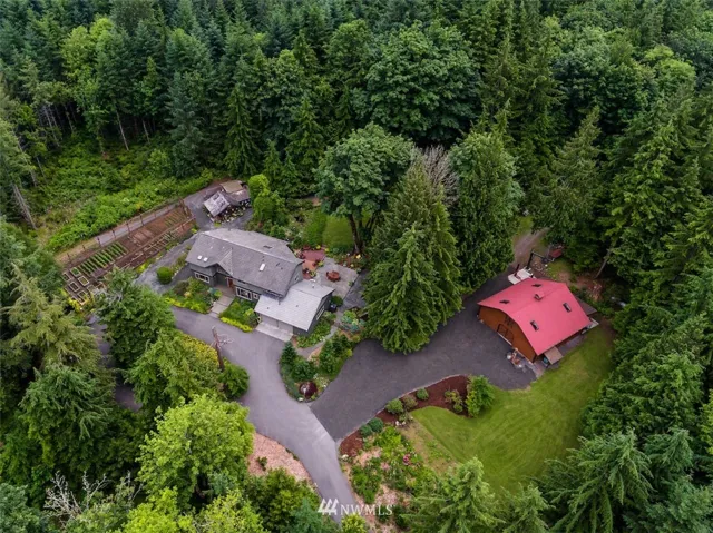 If you don't know Preston it is the next exit past Issaquah.  It is a small town highlighted by the soccer fields, the old mill, and one of the best kept secrets in King County - the Mitchell Hill neighborhood.  A neighborhood of custom homes on 5-20 acre lots. This home is only 4.2 miles from I-90 - a short commute relative to Snoqualmie and North Bend.  Great schools- Clark Elementary, Issaquah Middle, and Issaquah High School.  This home boasts nearly 5 acres, amazing shop/stable, garden, as well as potting shed which is more of a garden house and an incredible private setting.