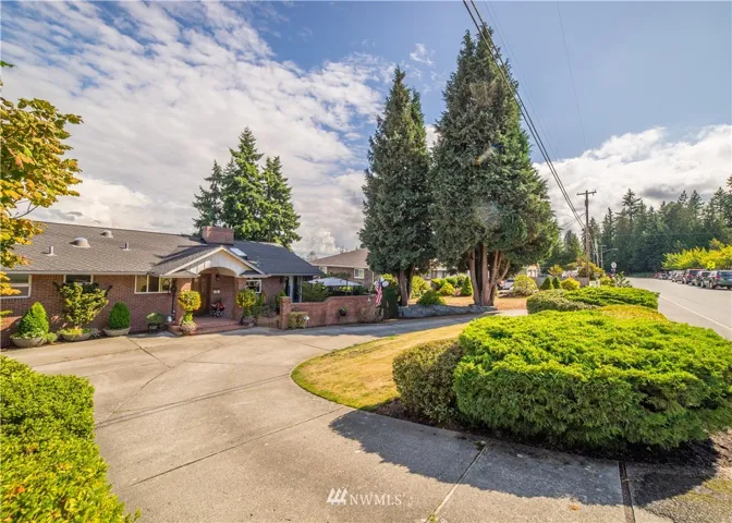 Circular driveway with extra parking to the left of picture. There is enough parking for numerous cars on this property.