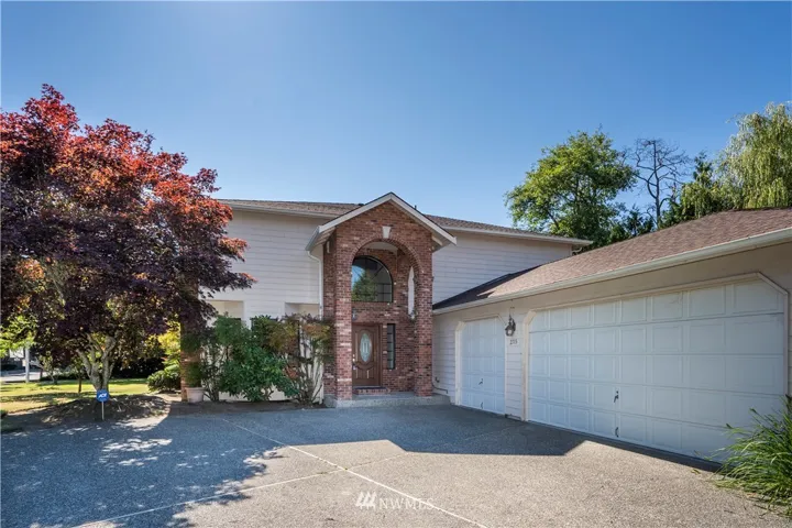 Front of house - 3 car garage & mature landscaping
