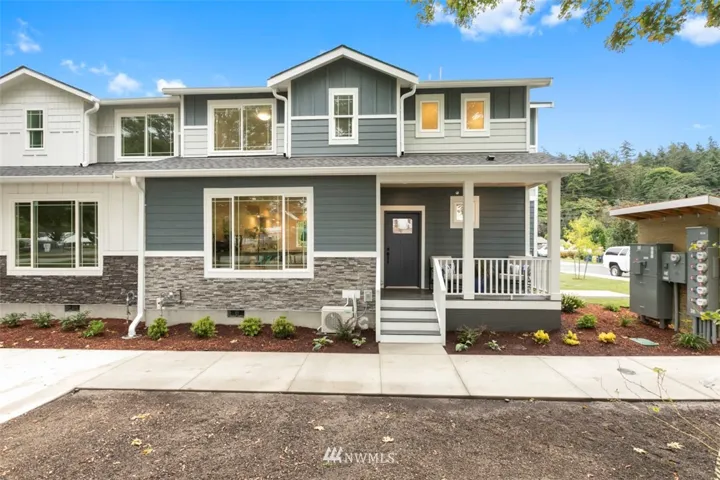 The covered front porch faces the city park. The large window is located in the living room. Upstairs on the left is side bedroom, center window is the hall bathroom, windows on the right is the Master bathroom.