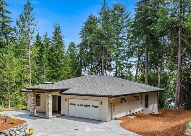 This brand new, custom, construction home sits atop high bank waterfront on Pickering Passage with views extending to Harstine Island in the background.