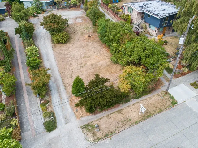Builder Alert! A remarkable and rare vacant residential lot located in the Seaview neighborhood of West Seattle. At 7201 sqft, and depending on design, you'll have the option of Puget Sound, mtn & island views as well. Gently sloping towards 51st Ave SW, the lot features a few trees and mature landscaping. Surveyed, with water, sewer & gas available. Just blocks from Beach Dr SW, Me-Kwa-Mooks and Ercolini Parks. Close to Alaska Junction, shops, restaurants and buses to downtown Seattle & SeaTac.