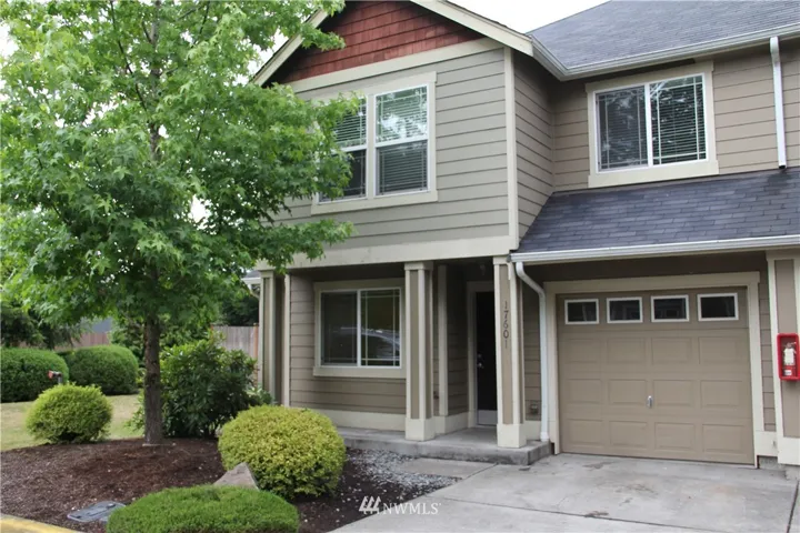 Contemporary front entrance with one car garage and extra parking spot