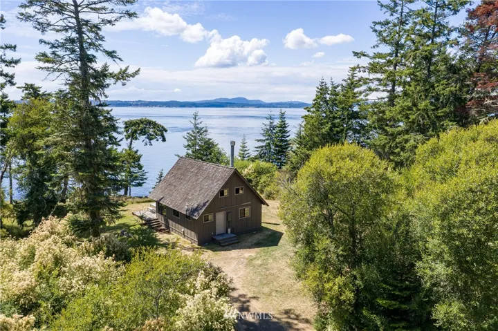 Above Shark Reef on the west side of Lopez sits this 2 bedroom, 1 bath beach cabin on nearly 1.25 acres with 100 ft of waterfront.