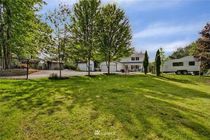 Look to the left and you will see a full sized chicken coup and run, large storage shed stays with the home and fully insulated well house features full house water softener.
