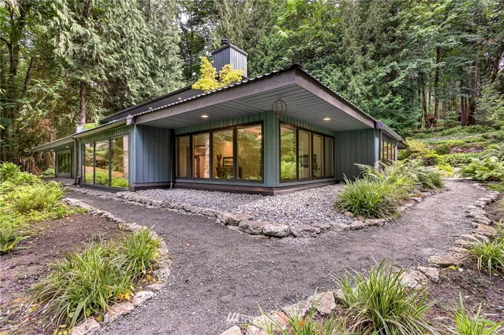 Walls of window and winding paths greet you as you enter the property