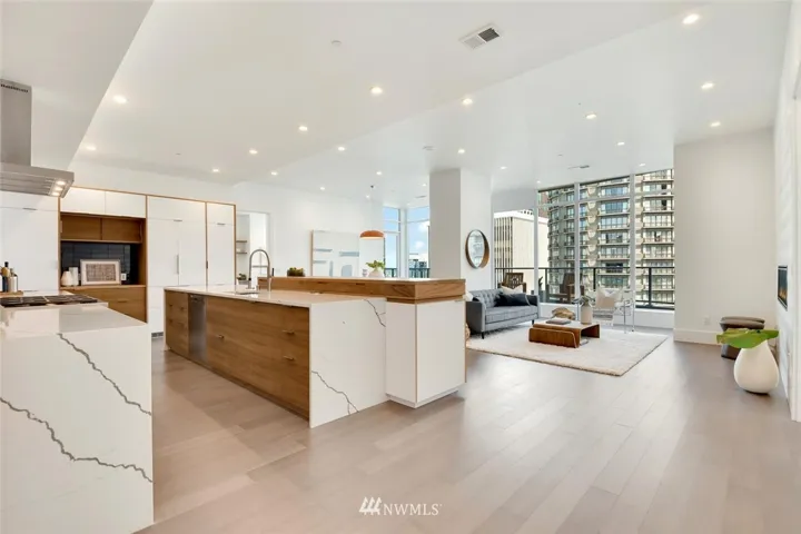 Luxurious Escala penthouse with European / Mid Century Modern inspired design featuring custom teak cabinetry by Plum Projects throughout and carefully selected high-end materials with pops of color and sleek clean lines for a timeless, functional, and minimalistic feel