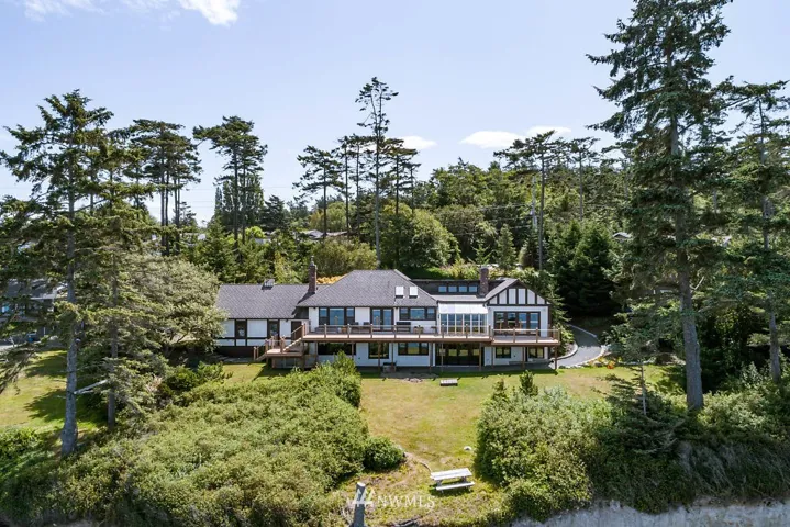 Wow! This Tudor-style home, set on 1.5 acres...is AMAZING...