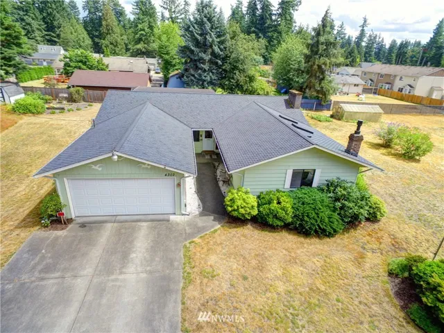 Well built rambler with 50 year roof, heat pump, hardwood floors, a pellet stove and a gas freestanding stove. Large living room, remodeled kitchen, good sized rec room with wet bar and vaulted ceilings. Three bedrooms and just over 2000 sq. ft. Covered patio in the back and covered carport.....with the detached shop parking for 7 cars. House on a small lot would be approx. $400,000 ++......value in additional lots from a short plat....probable 10 ? SFR lots or do condo or multi family & get more