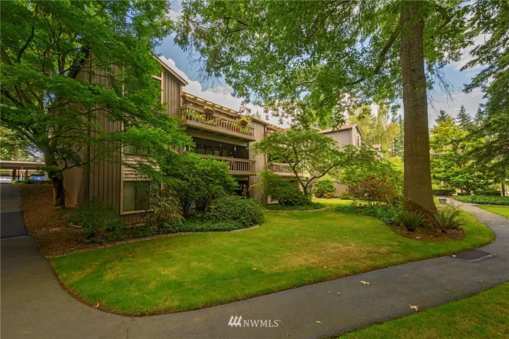 This view of the condominium's deck is from the garden space leading to the pool.  These landscaped grounds are over six acres with a gate surrounding the entire property.