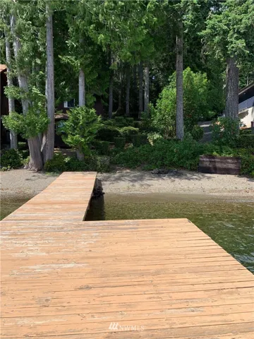Huge existing dock ready for your water vessels and sunbathing! =)  And look at that nice pebbly beach!