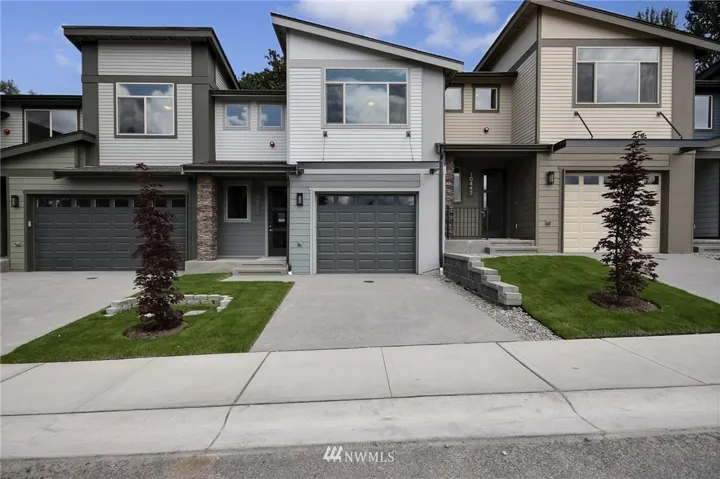 2 Car Tandem Garage with long driveway, covered front porch and sleek color palette.