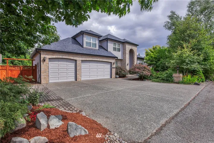 Large driveway for 3 car garage and additional side parking if needed.