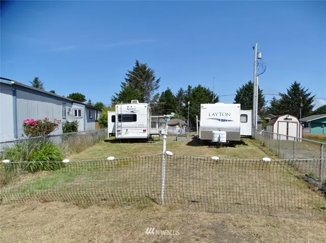 Front of this year-round camping lot in Div 12 w/ 3 travel trailers.