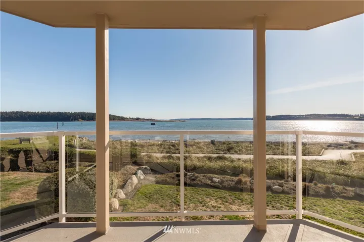 Waterfront living at its best! Covered deck with glass panels to enjoy the full view while relaxing or entertaining!