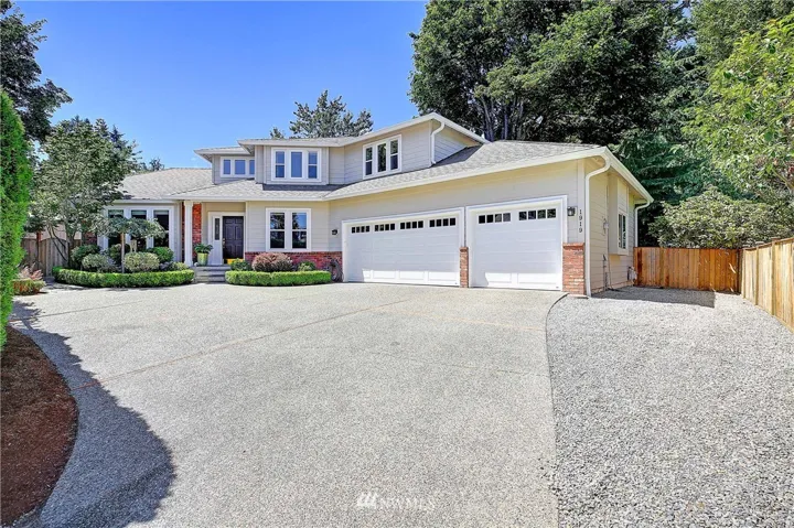 Large parking area with three car garage and rv or small boat parking on side