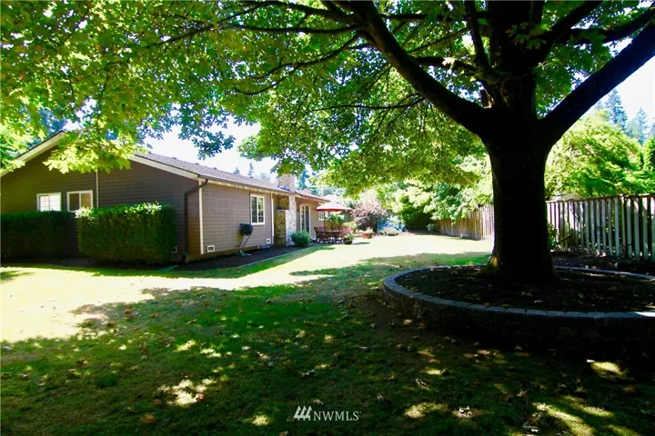 Backyard is private, fenced, and shaded by the beautiful maple tree